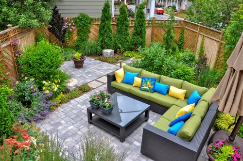 A beautiful small, urban backyard garden featuring a tumbled pav