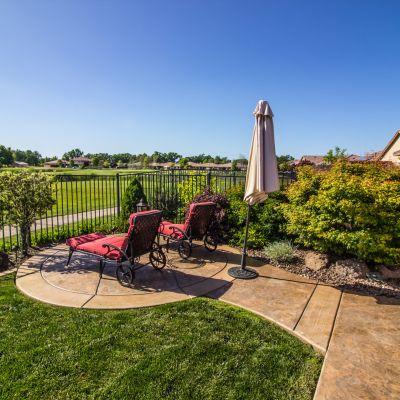 Lounge Chairs Overlooking Green Field & Blue Pond