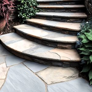A meandering flagstone walkway winds its way up a staircase, pro