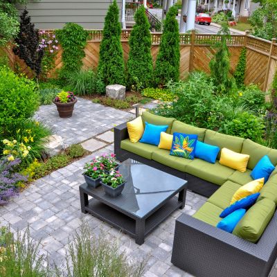 A beautiful small, urban backyard garden featuring a tumbled pav